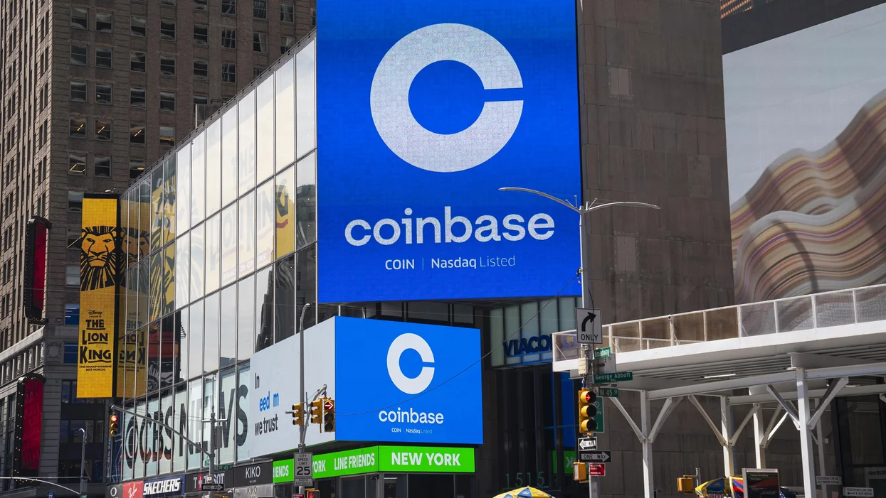 new york ny april 14 monitors display coinbase signage during the company s initial public offering ipo at the nasdaq mark